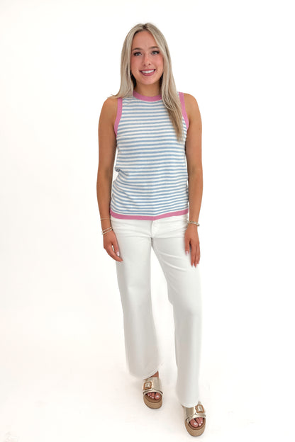 Front view of woman wearing Blue &amp; Lilac Striped Sweater Tank with jeans against white studio background.