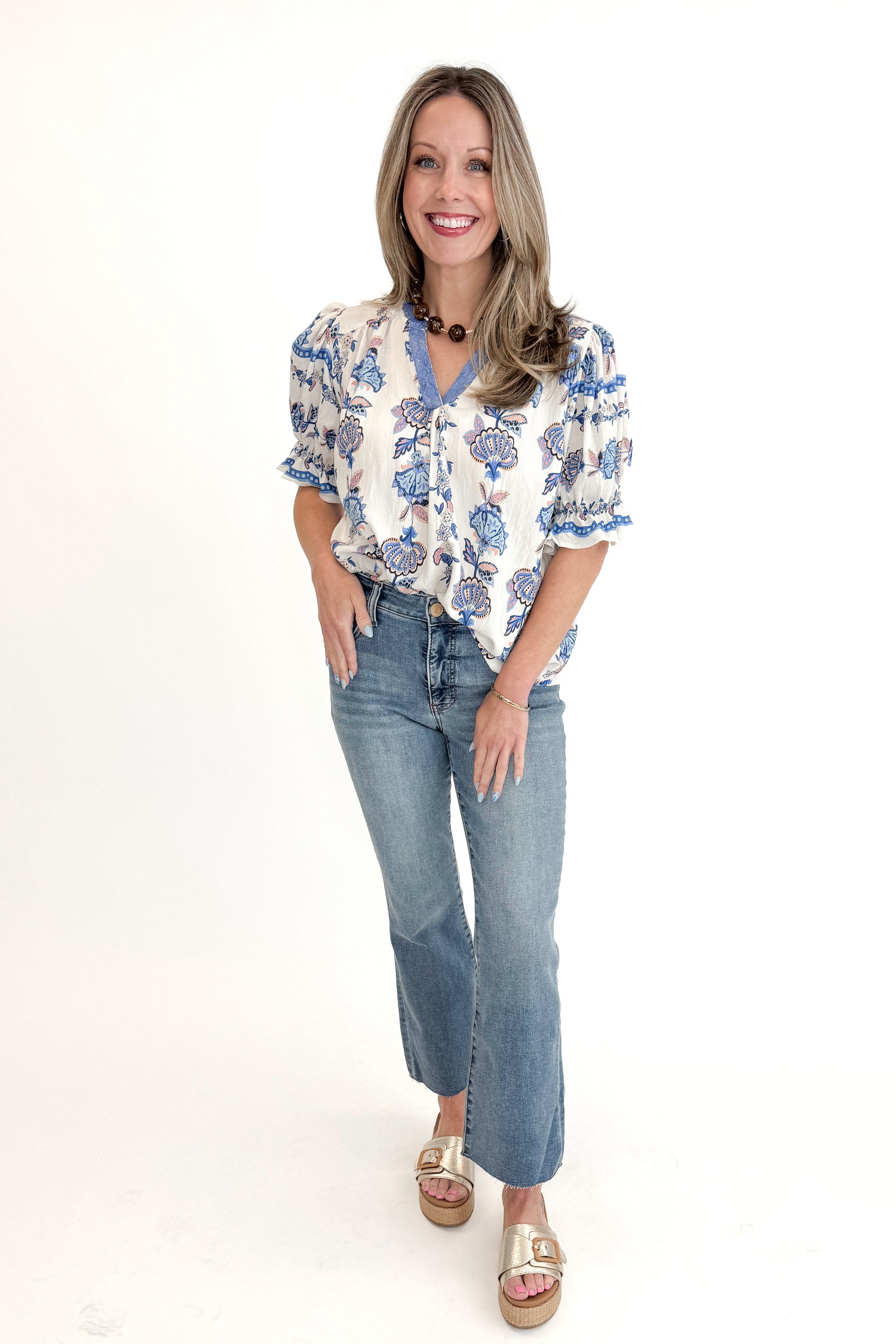 Front view of woman wearing Blue &amp; Multi Printed Lace Detail Top with jeans against white studio background.