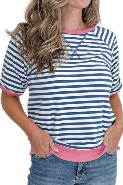 Front detail view of woman wearing Swagger Boutique’s Blue &amp; Pink Striped Short Sleeve Sweatshirt with jeans against white studio background.