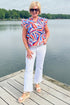 Front view of woman wearing Swagger Boutique’s Blue & Red Printed Ruffle Sleeve Top by Skies Are Blue and jeans outside at the lake.