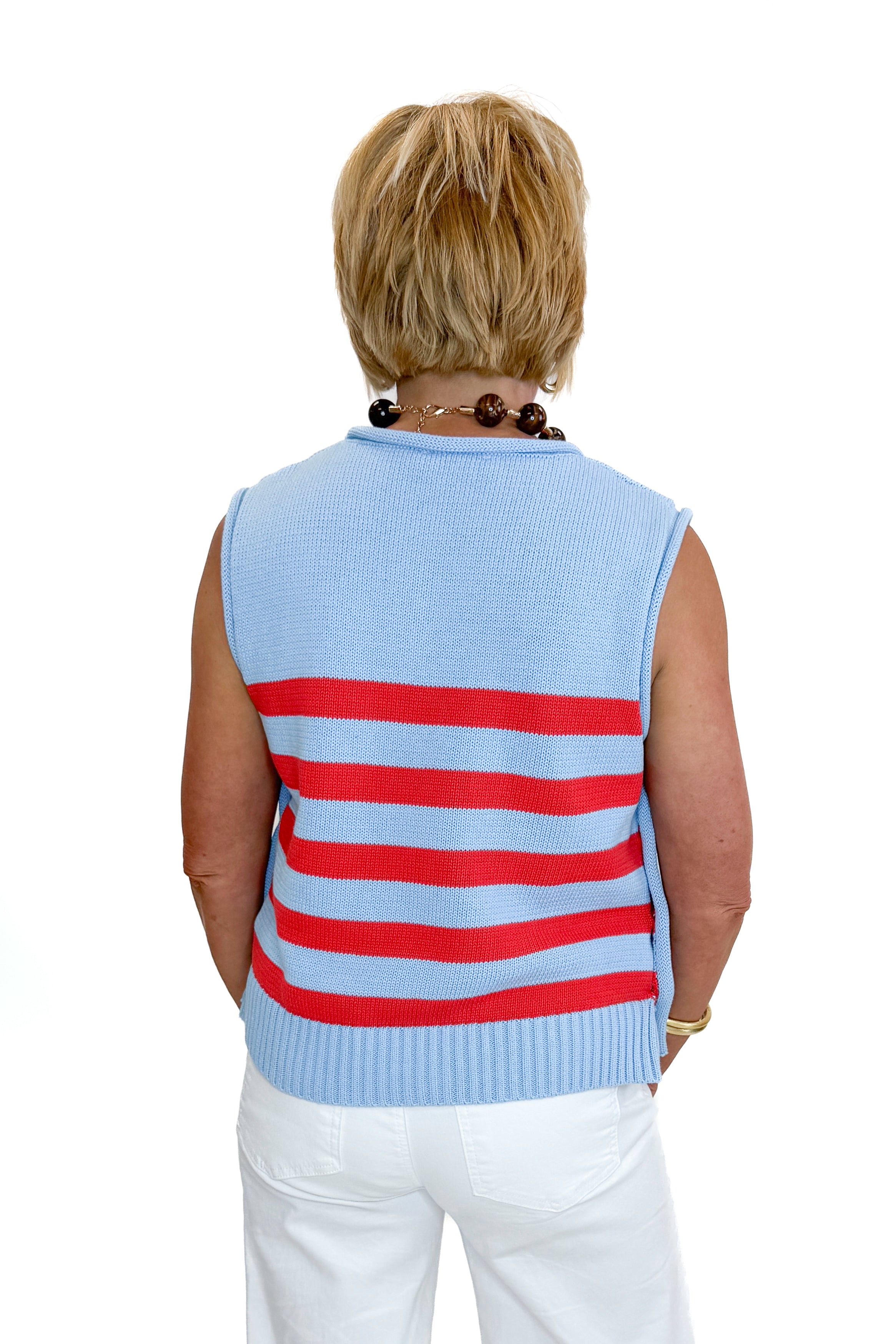 Back view of woman wearing Swagger Boutique’s Blue &amp; Red Striped Sleeveless Sweater by Entro with jeans against white studio background.