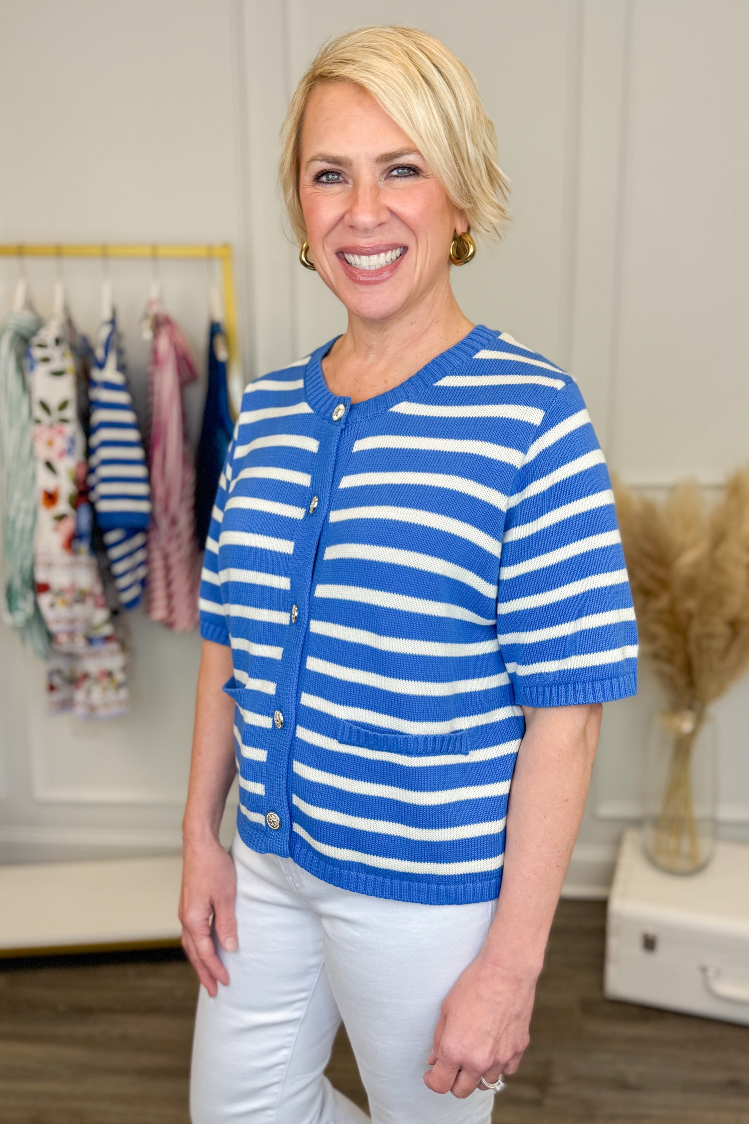 Side view of woman wearing Blue Striped Button Up Short Sleeve Sweater with jeans at Swagger Boutique.