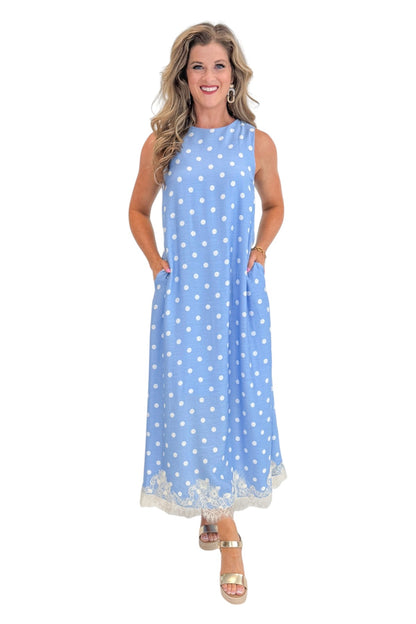 Front view of woman wearing Swagger Boutique’s Blue &amp; White Polka Dot Lace Trim Maxi Dress by Entro with wedges against white studio background.