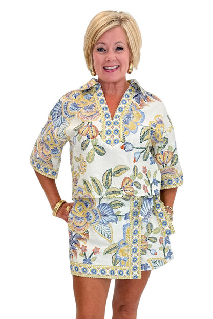 Front view of woman wearing Swagger Boutique’s Blue &amp; Yellow Floral Print Wrap Skort by Entro with matching top against white studio background.