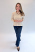 Front view of woman wearing Swagger Boutique’s Bone Ribbed Lightweight Sweater with jeans against white studio background.
