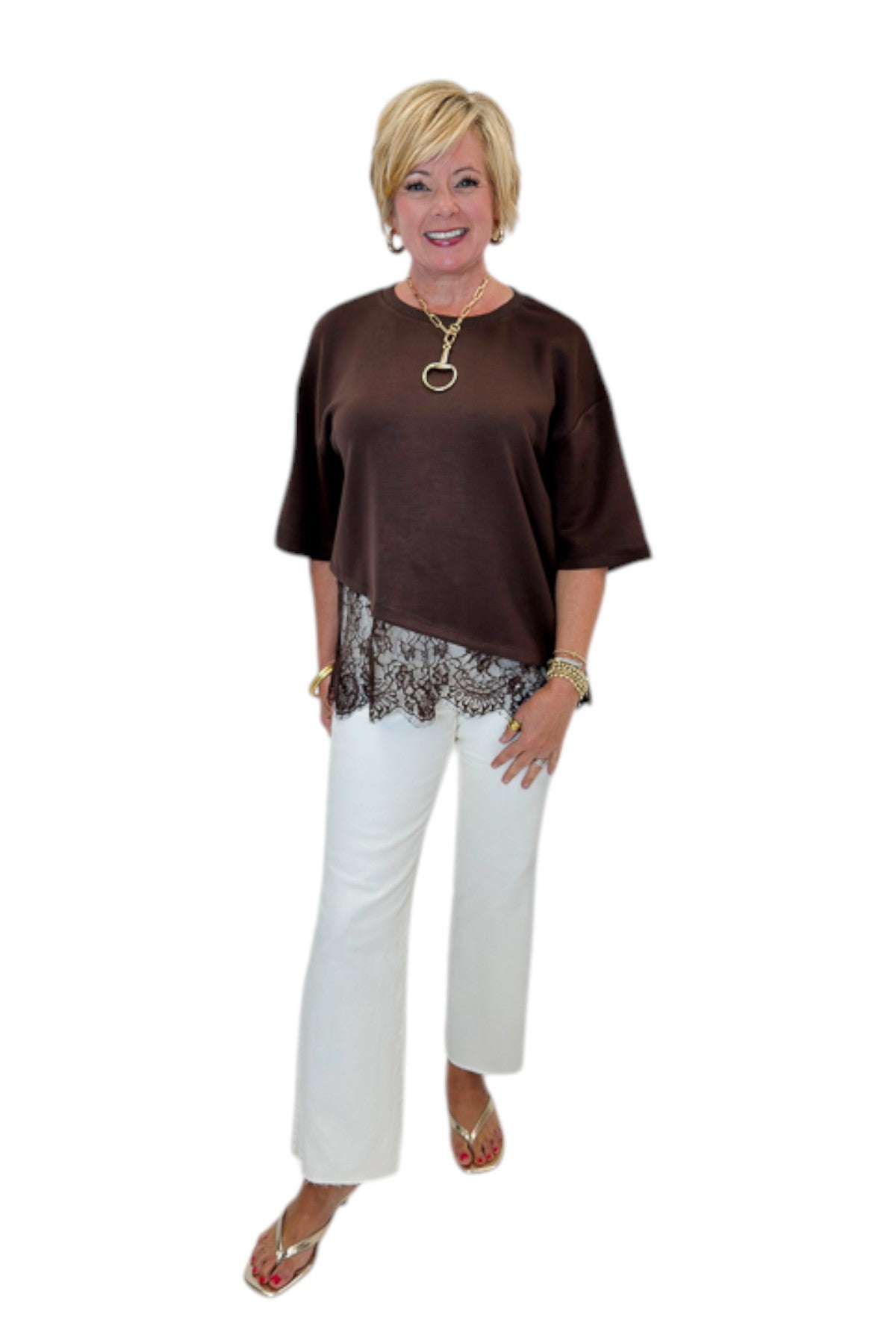 Front view of woman wearing Swagger Boutique’s Brown Asymmetrical Lace Hem Top by Entro with jeans against white studio background.