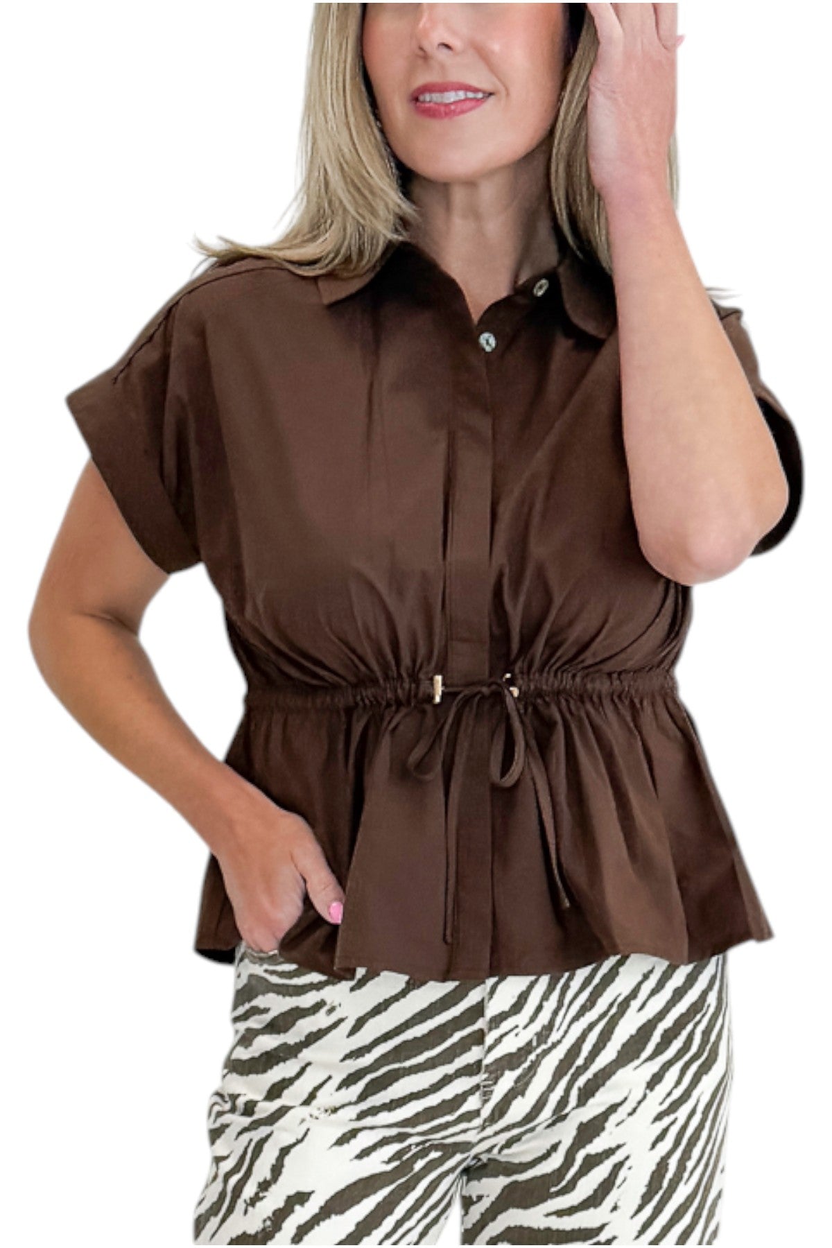 Front detail view of woman wearing Swagger Boutique’s Brown Cinched Waist Short Sleeve Top with zebra jeans against white studio background.