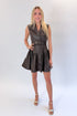 Front view of woman wearing Swagger Boutique’s Brown Faux Leather Mini Dress with heels against white studio background.