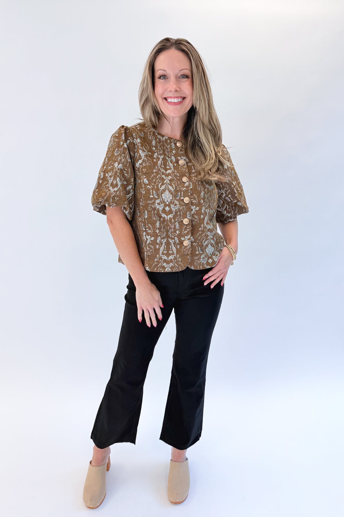 Front view of woman wearing Swagger Boutique’s Brown Floral Corduroy Top with jeans against white studio background.
