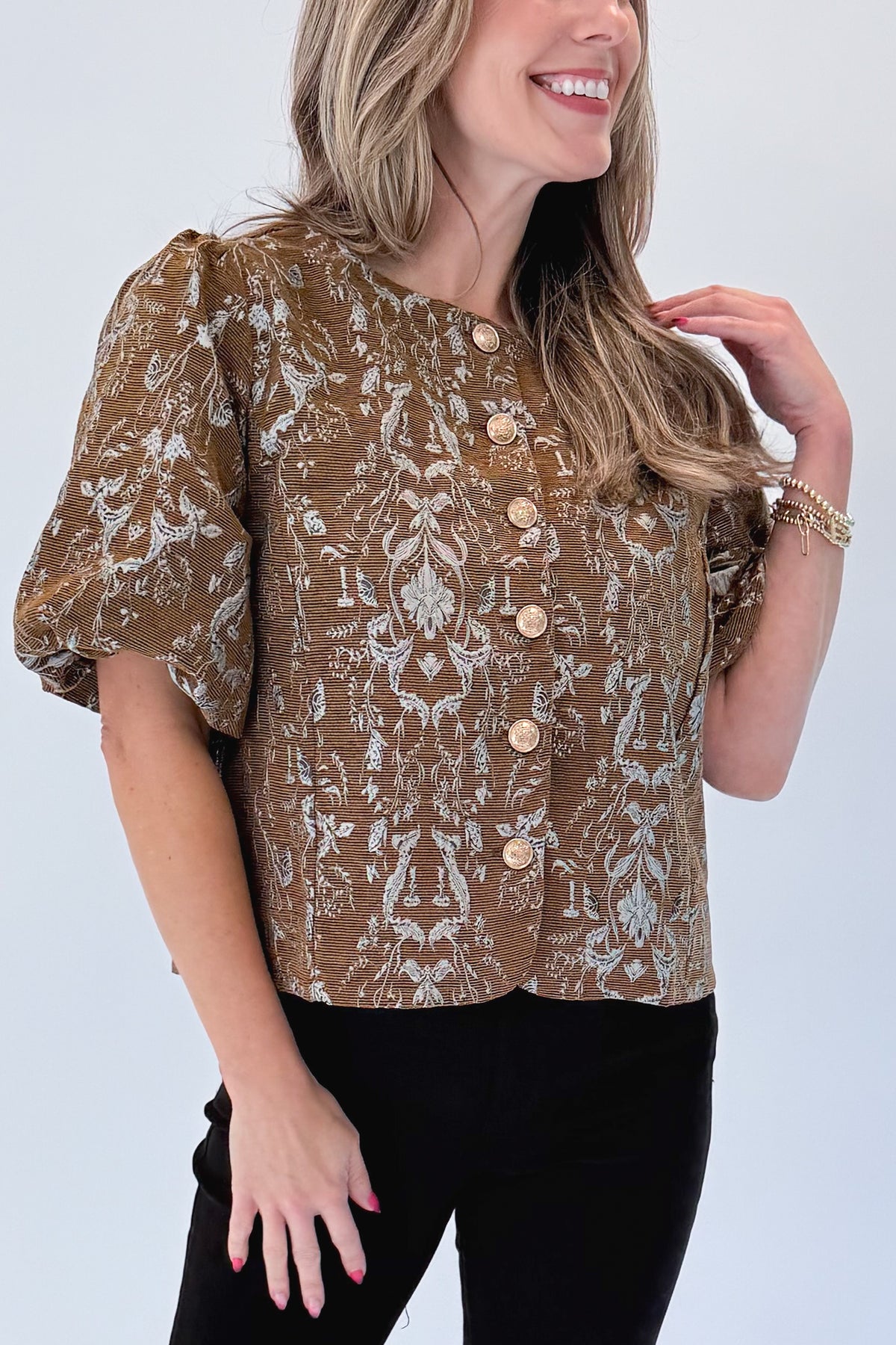 Front detail view of woman wearing Swagger Boutique’s Brown Floral Corduroy Top with jeans against white studio background.