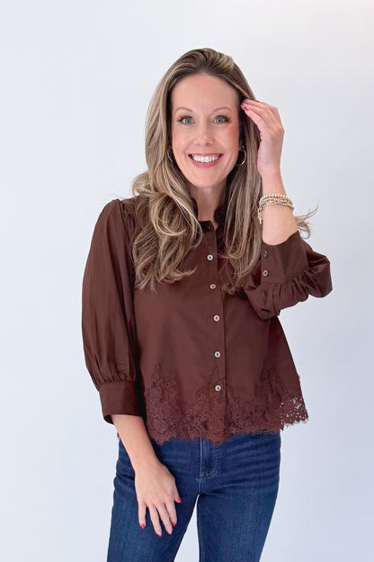 Front view of woman wearing Swagger Boutique’s Brown Lace Lined Button Up Top by Entro with jeans against white studio background.
