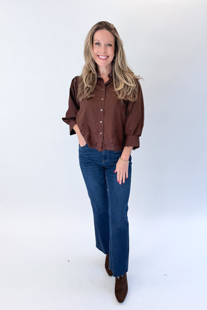 Front view of woman wearing Swagger Boutique’s Brown Lace Lined Button Up Top by Entro with jeans against white studio background.