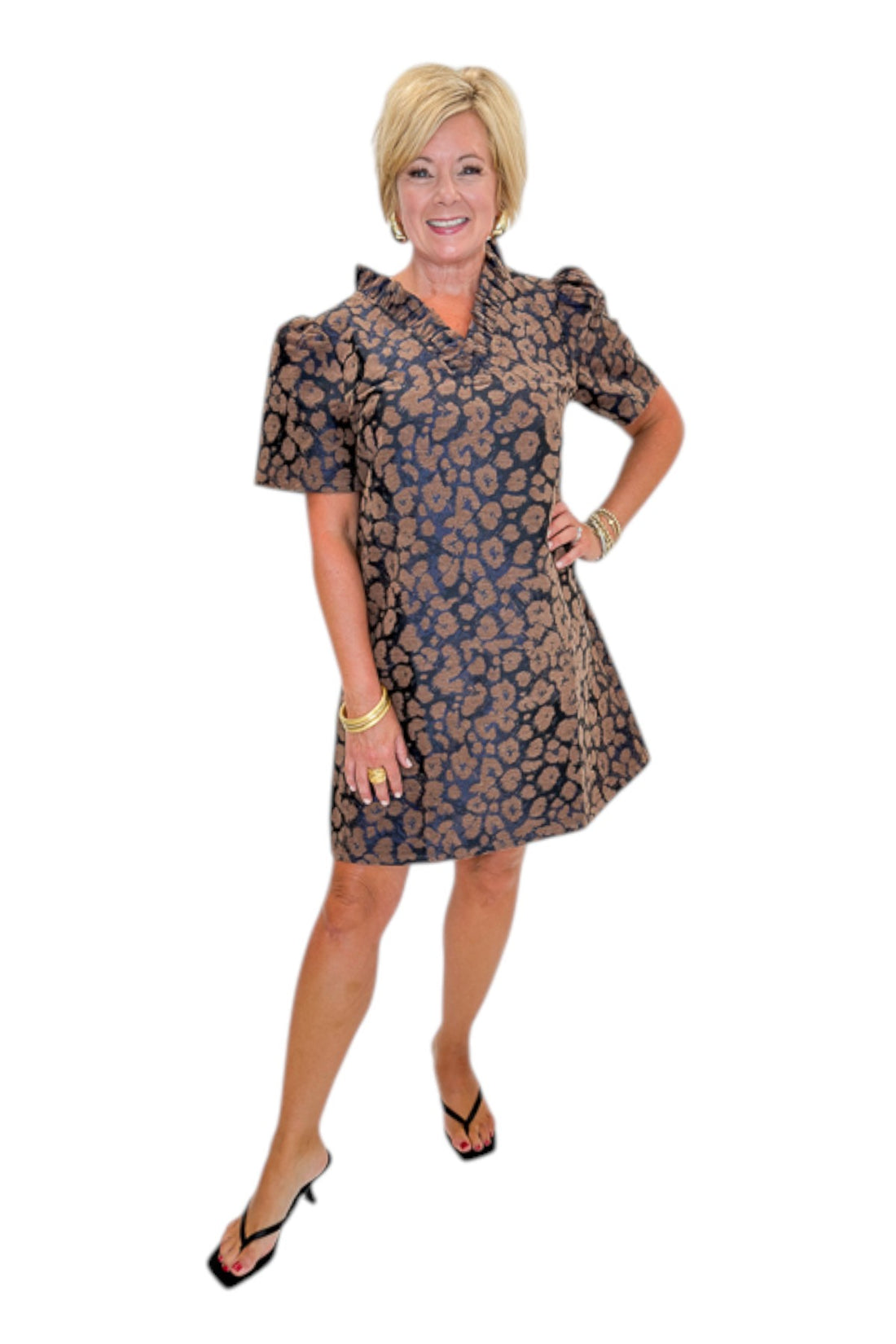 Front view of woman wearing Swagger Boutique’s Brown Leopard Velvet V-Neck Dress with heels against white studio background.