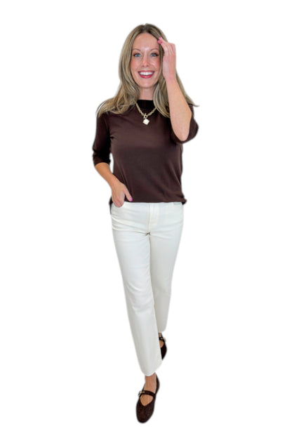 Front view of woman wearing Swagger Boutique’s Brown Lightweight Half Sleeve Sweater with jeans against white studio background.