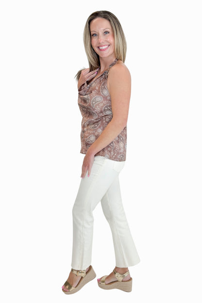 Side view of woman wearing Swagger Boutique’s Brown Paisley Halter Neck Tank with jeans against white studio background.