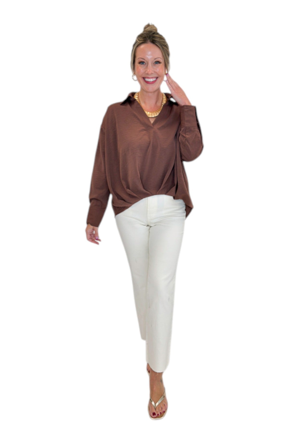 Front view of woman wearing Swagger Boutique’s Brown Pleated Long Sleeve Top by Entro with jeans against white studio background.