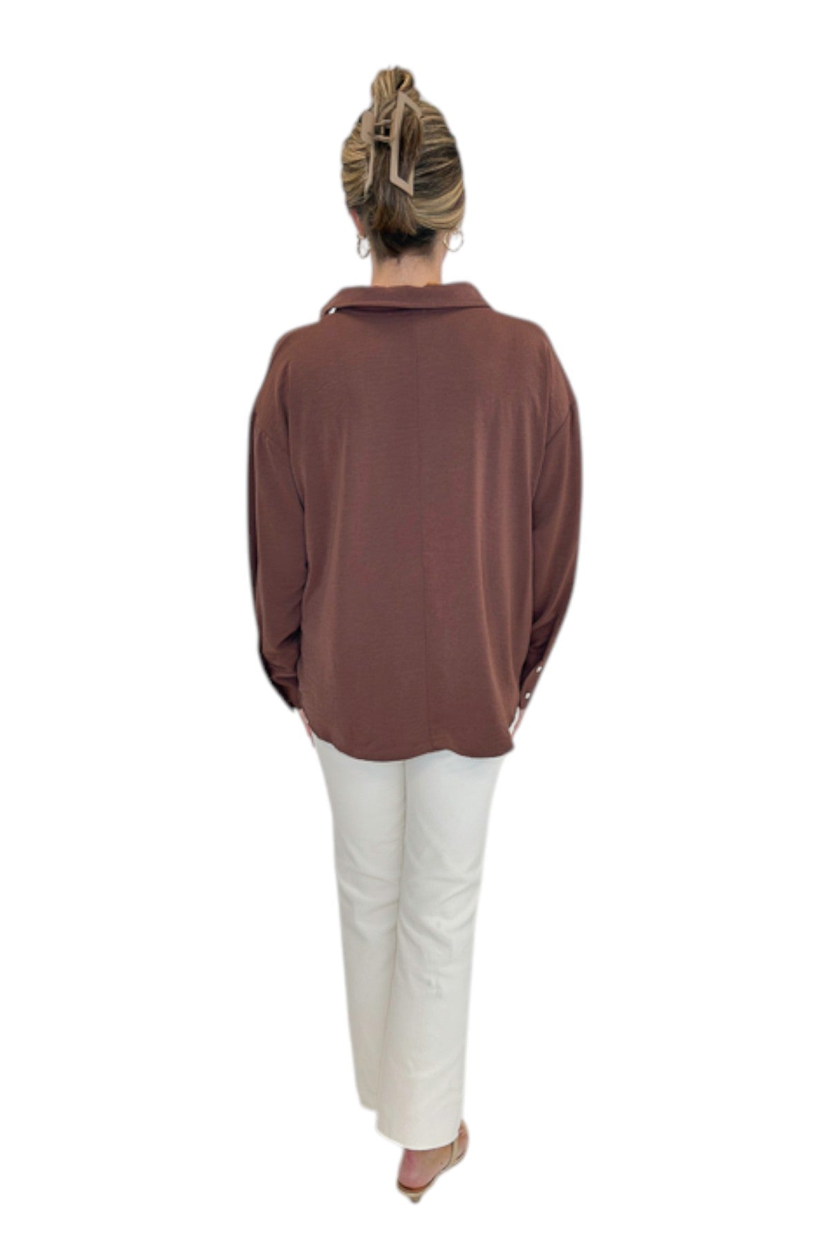 Back view of woman wearing Swagger Boutique’s Brown Pleated Long Sleeve Top by Entro with jeans against white studio background.