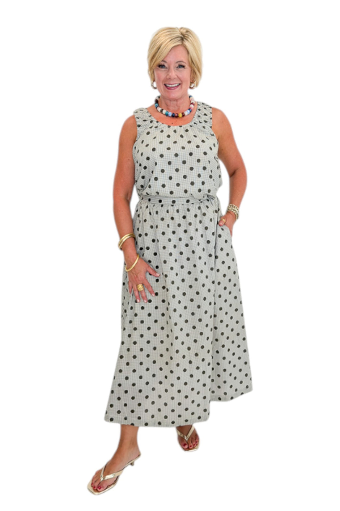 Front view of woman wearing Swagger Boutique’s Brown Polka Dot Bubble Hem Tank and Midi Skirt by Entro against white studio background.