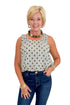 Front view of woman wearing Swagger Boutique’s Brown Polka Dot Bubble Hem Tank with jeans against white studio background.