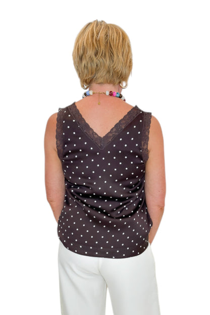 Back view of woman wearing Swagger Boutique’s Brown Polka Dot Lace Trim Tank with Cream Lace Lined Pants against white studio background.
