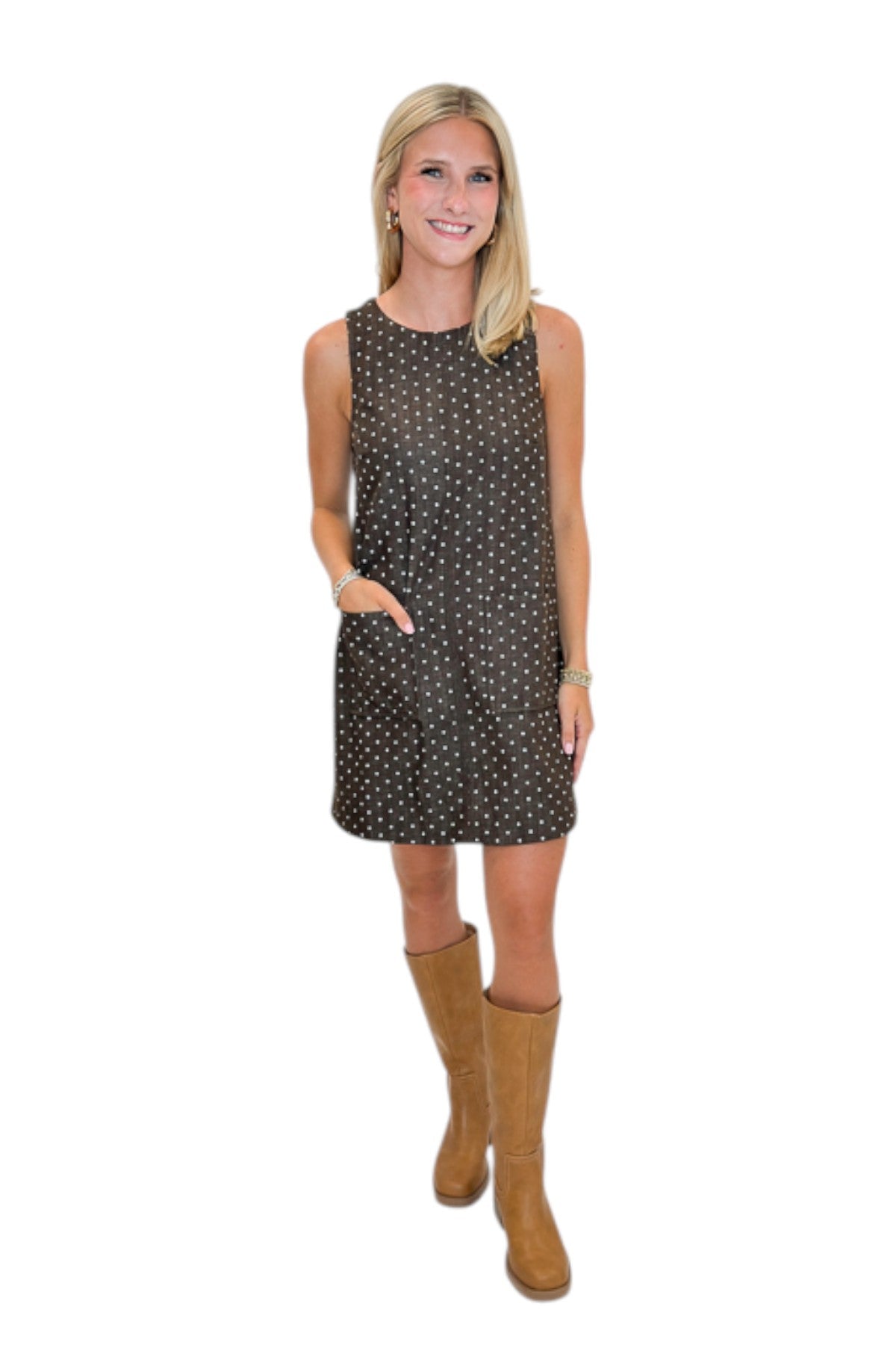 Front view of woman wearing Swagger Boutique’s Brown Polka Dot Shift Dress with boots against white studio background.