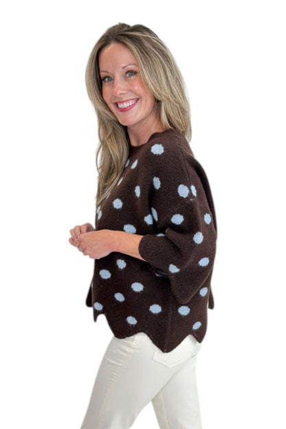 Side view of woman wearing Swagger Boutique’s Brown Polka Dot Short Sleeve Sweater by Entro with jeans against white studio background.