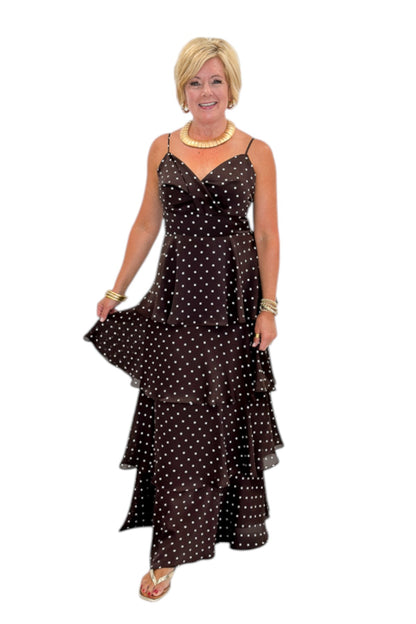 Front view of woman wearing Swagger Boutique’s Brown Polka Dot Tiered Maxi Dress with heels against white studio background.