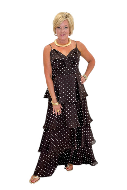 Front view of woman wearing Swagger Boutique’s Brown Polka Dot Tiered Maxi Dress with heels against white studio background.