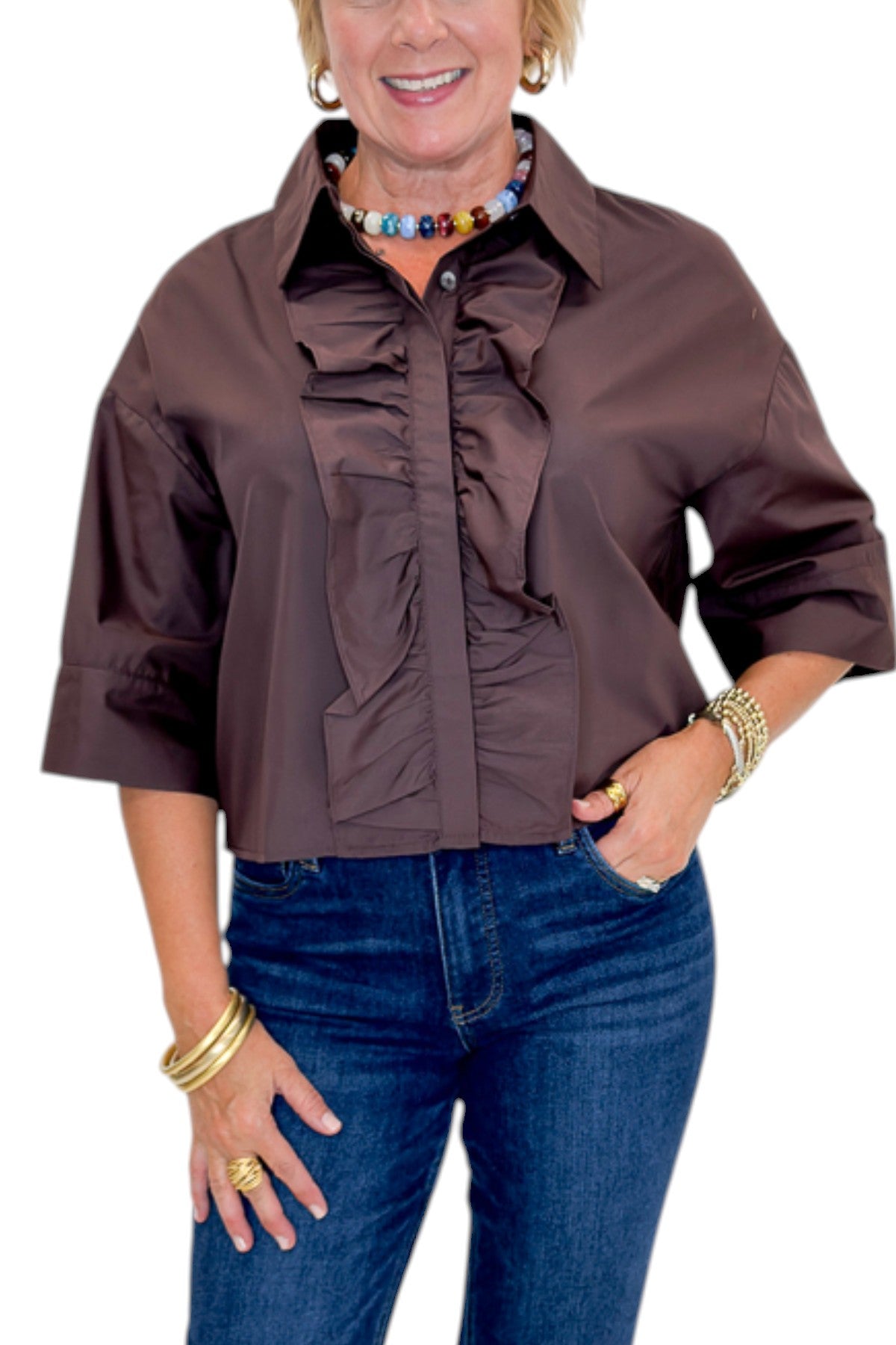 Front detail view of woman wearing Swagger Boutique’s Brown Ruffle Trim 3/4 Sleeve Top by Entro with jeans against white studio background.