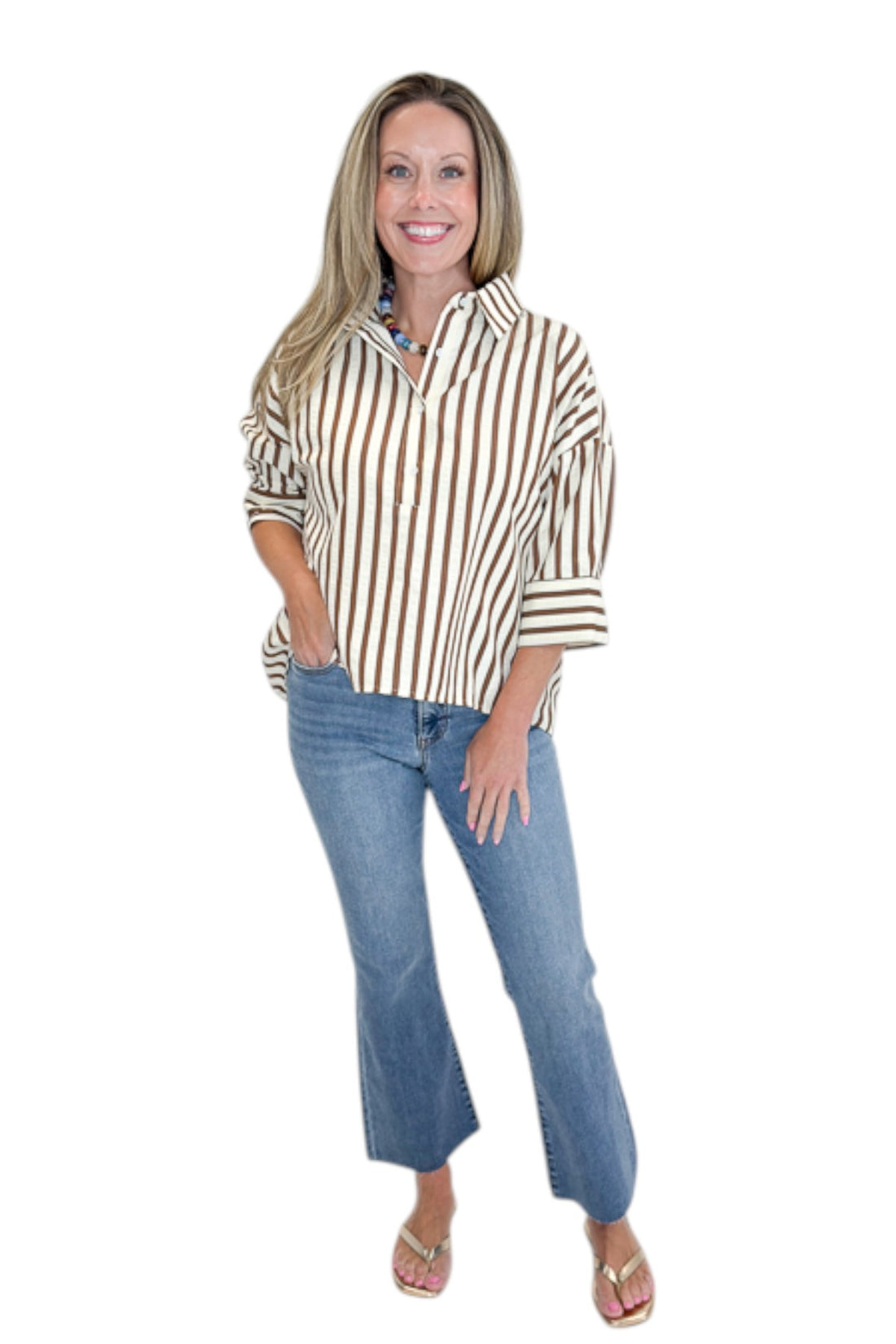 Front view of woman wearing Swagger Boutique’s Brown Striped 3/4 Sleeve Top with jeans against white studio background.