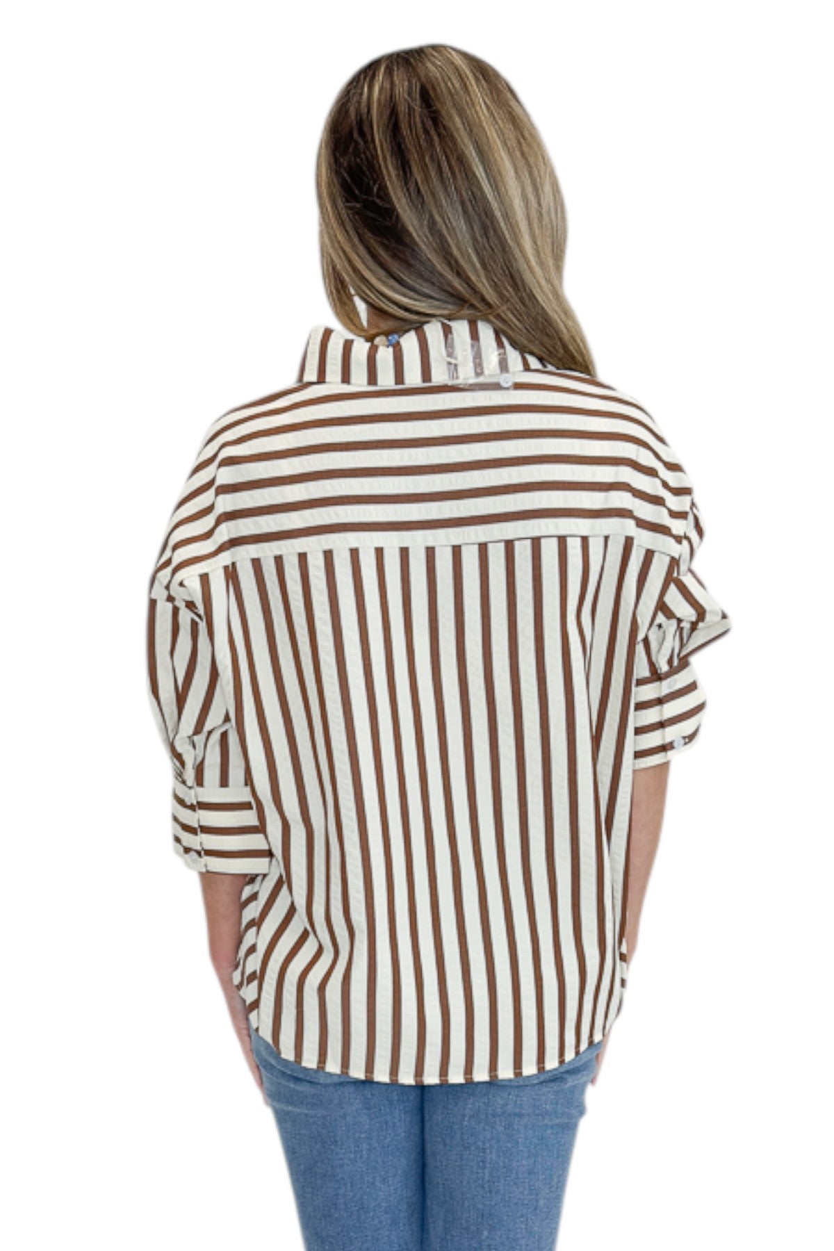 Back view of woman wearing Swagger Boutique’s Brown Striped 3/4 Sleeve Top with jeans against white studio background.