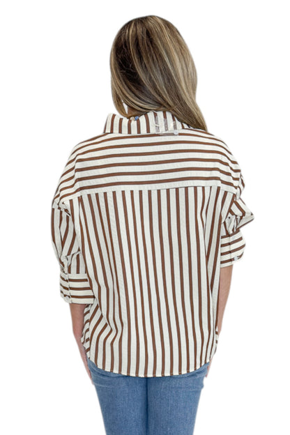 Back view of woman wearing Swagger Boutique’s Brown Striped 3/4 Sleeve Top with jeans against white studio background.