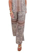 Front view of woman wearing Swagger Boutique’s Brown Zebra Tank by Entro with Wide Leg Pants against white studio background.