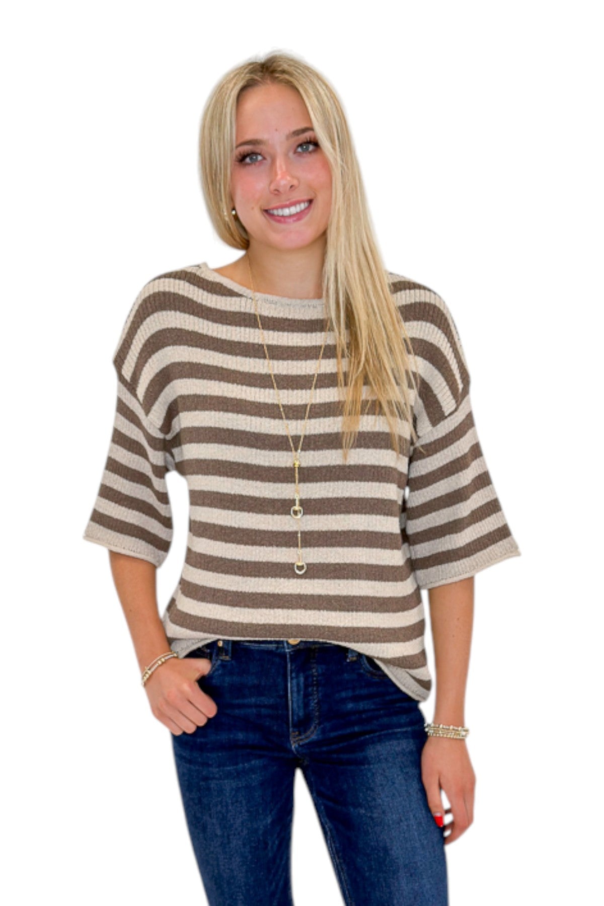 Front view of woman wearing Swagger Boutique’s Brown &amp; Beige Striped Short Sleeve Sweater with jeans against white studio background.