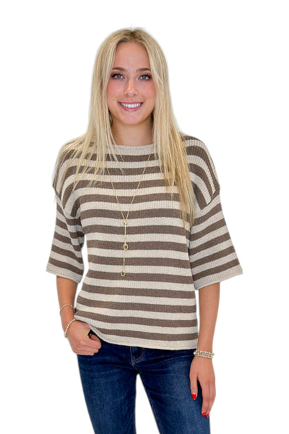 Front view of woman wearing Swagger Boutique’s Brown &amp; Beige Striped Short Sleeve Sweater with jeans against white studio background.