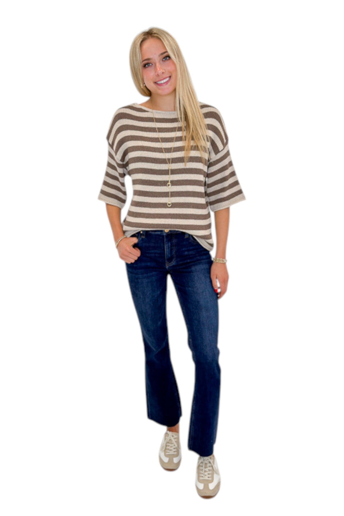 Front view of woman wearing Swagger Boutique’s Brown &amp; Beige Striped Short Sleeve Sweater with jeans against white studio background.