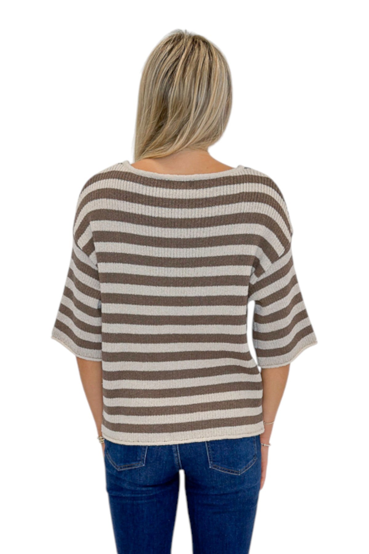 Back view of woman wearing Swagger Boutique’s Brown &amp; Beige Striped Short Sleeve Sweater with jeans against white studio background.