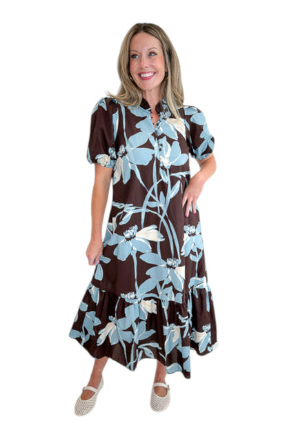 Front view of woman wearing Swagger Boutique’s Brown &amp; Blue Floral Midi Dress by Entro against white studio background.