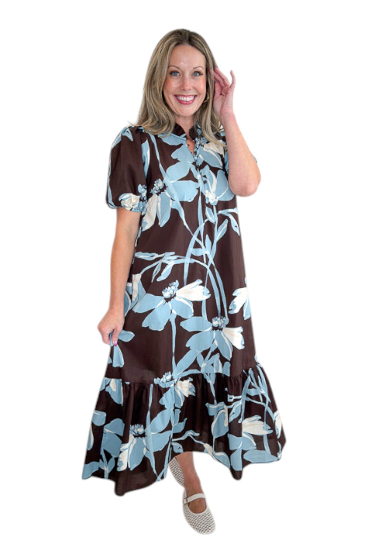 Side view of woman wearing Swagger Boutique’s Brown &amp; Blue Floral Midi Dress by Entro against white studio background.