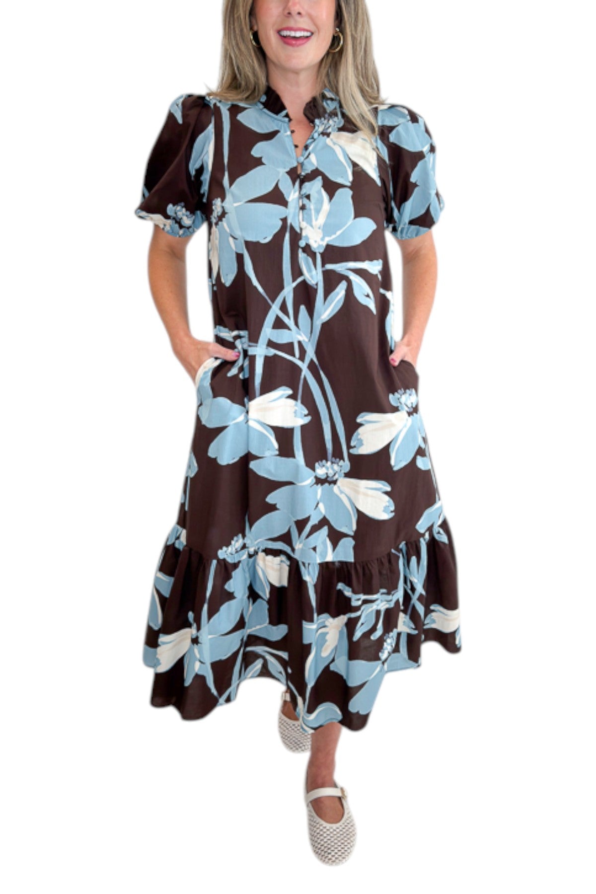 Front detail view of woman wearing Swagger Boutique’s Brown &amp; Blue Floral Midi Dress by Entro against white studio background.