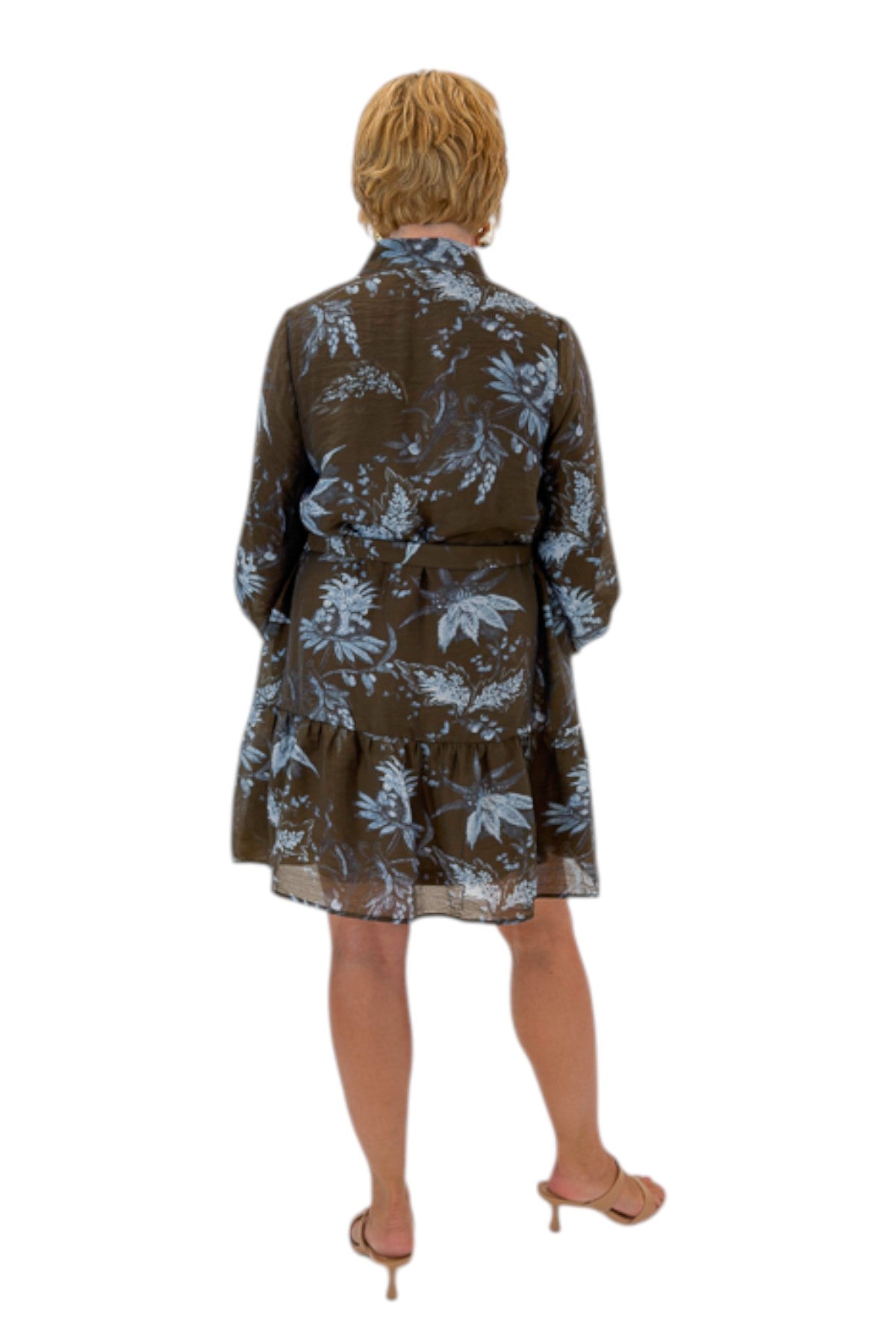 Back view of woman wearing Swagger Boutique’s Brown &amp; Blue Floral Tie Waist Mini Dress against white studio background.