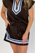 Front detail view of woman wearing Swagger Boutique’s Brown & Blue Mini Skirt and Half Zip Top by Entro against white studio background.