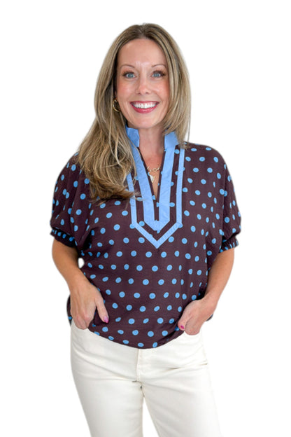 Front view of woman wearing Swagger Boutique’s Brown &amp; Blue Polka Dot Dolman Sleeve Top by Entro with jeans against white studio background.