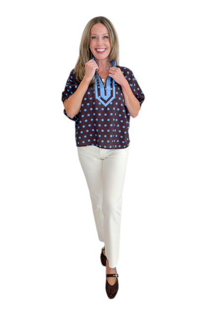 Front view of woman wearing Swagger Boutique’s Brown &amp; Blue Polka Dot Dolman Sleeve Top by Entro with jeans against white studio background.