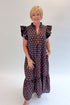 Front view of woman wearing Swagger Boutique’s Brown & Blue Polka Dot Midi Dress by Entro with heels against white studio background. 