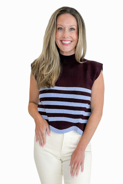 Front view of woman wearing Swagger Boutique’s Brown &amp; Blue Scallop Hem Sleeveless Sweater by Entro with jeans against white studio background.