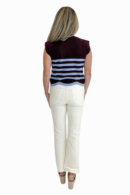 Back view of woman wearing Swagger Boutique’s Brown &amp; Blue Scallop Hem Sleeveless Sweater by Entro with Ecru jeans against white studio background.