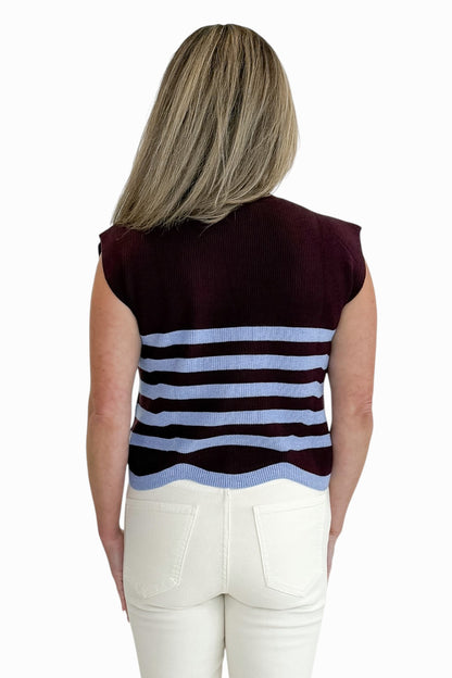 Back view of woman wearing Swagger Boutique’s Brown &amp; Blue Scallop Hem Sleeveless Sweater by Entro with jeans against white studio background.