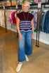 Front view of woman wearing Swagger Boutique’s Brown & Blue Scallop Hem Sleeveless Sweater by Entro with jeans standing at the store.