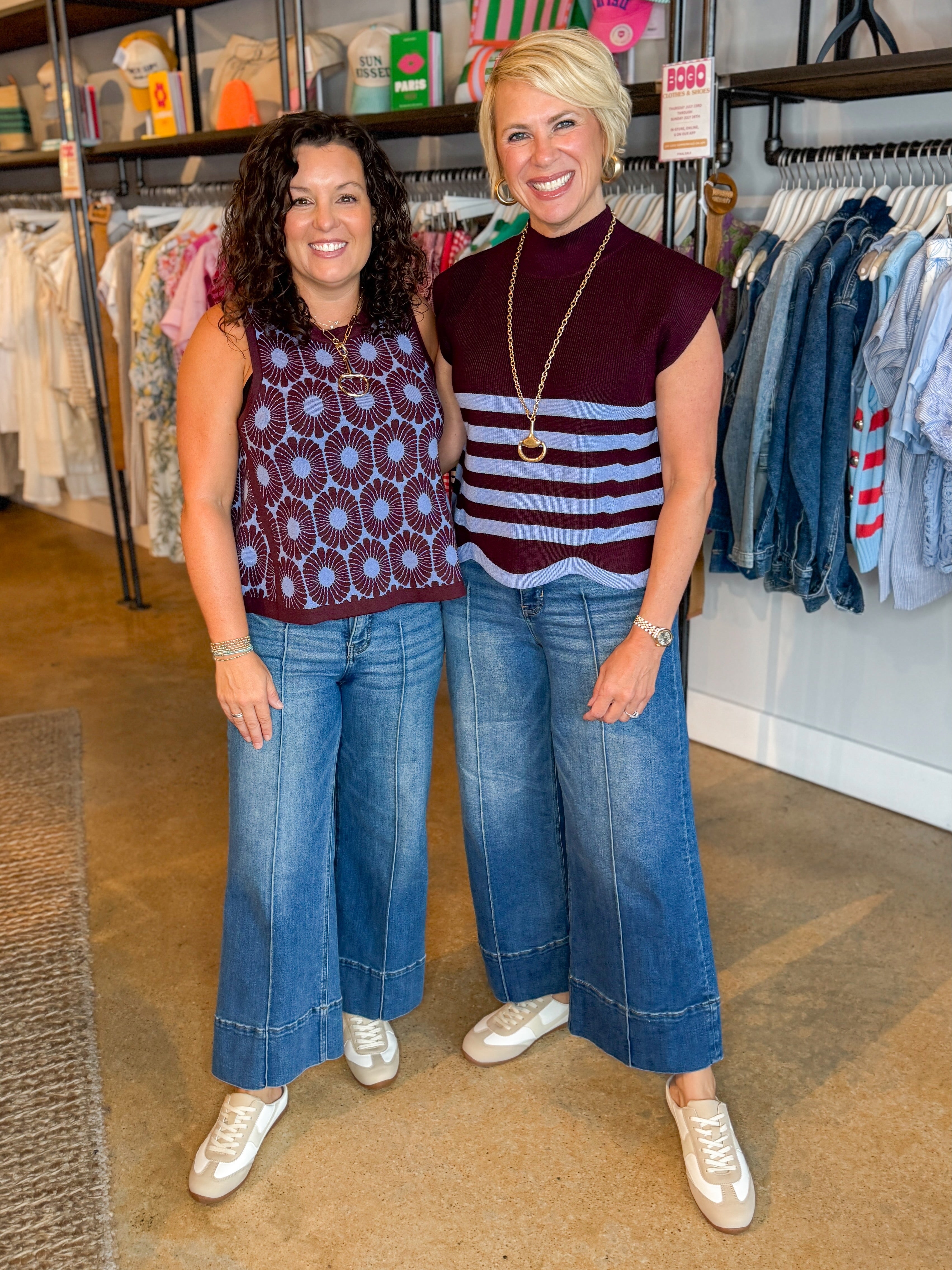 Front view of woman wearing Swagger Boutique’s Brown &amp; Blue Scallop Hem Sleeveless Sweater by Entro with jeans sand woman wearing Brown &amp; Blue Floral Tank standing at the store.